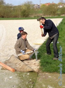 Martin Esdar und Christian Bittner kümmern sich um die Hülsen...  Mit Kraft werden sie in den Boden geschlagen..